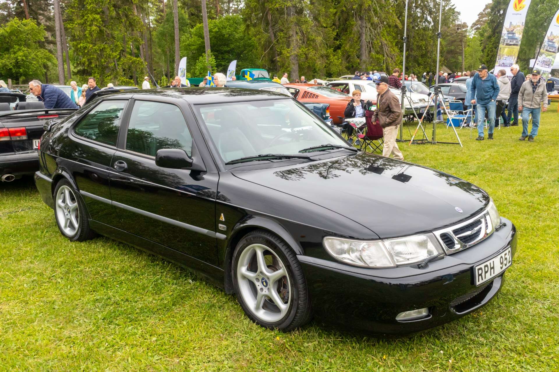 Black Saab 9-3 Viggen three-door with model-specific five-spoke alloy wheels and aero front bumper at a Swedish classic car meet