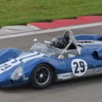 Today in Collector Car History: Dave MacDonald Wins at Laguna Seca in the Shelby King Cobra (Oct. 20, 1963) Blue Cooper Monaco King Cobra with white stripes and number 29 racing on a vintage circuit