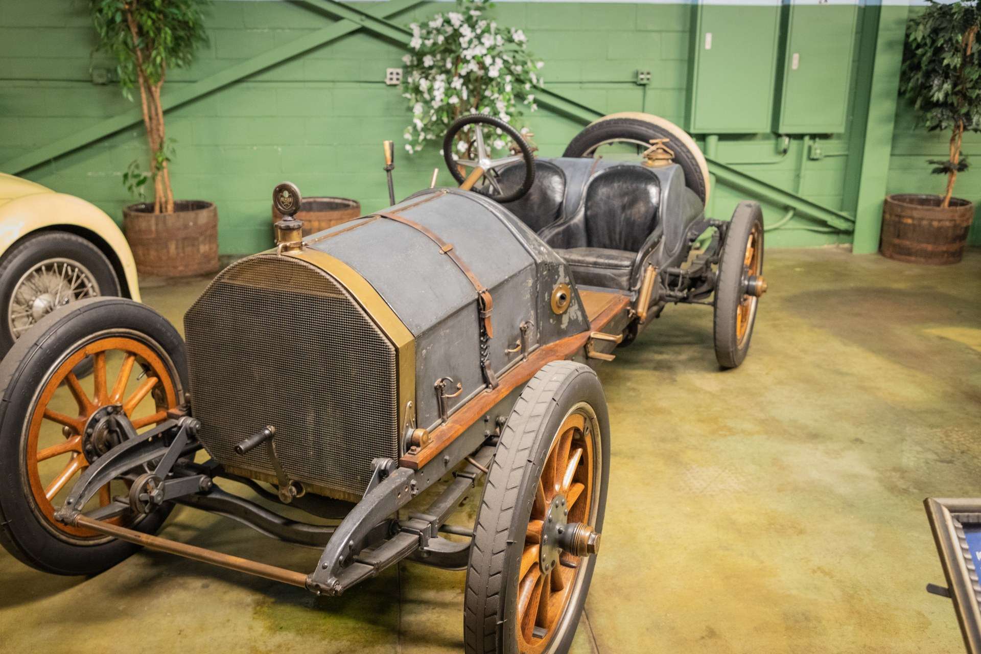 Unrestored 1913 Mercer Raceabout with worn dark paint and wooden-spoke wheels at the Simeone Foundation Automotive Museum