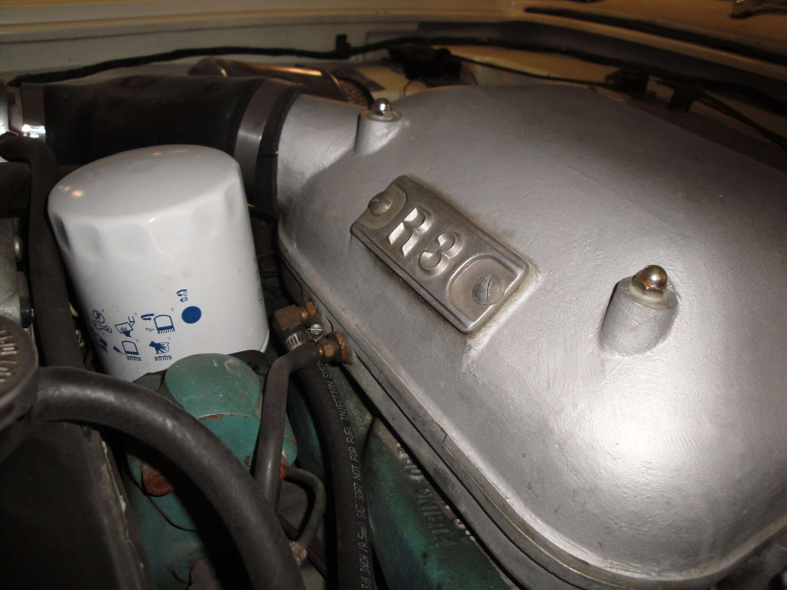 Cast R3 plate on the air box of a supercharged Studebaker Avanti V8, shown beside the oil filter