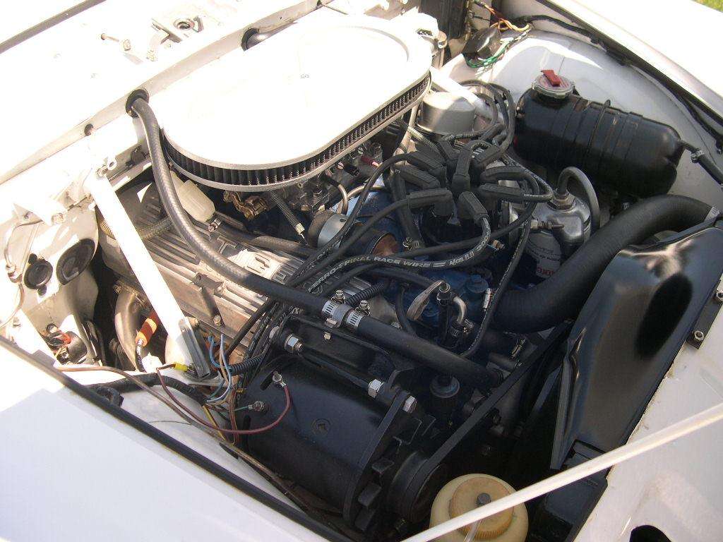 Ford V8 engine with air cleaner filling the tight engine bay of a white Sunbeam Tiger