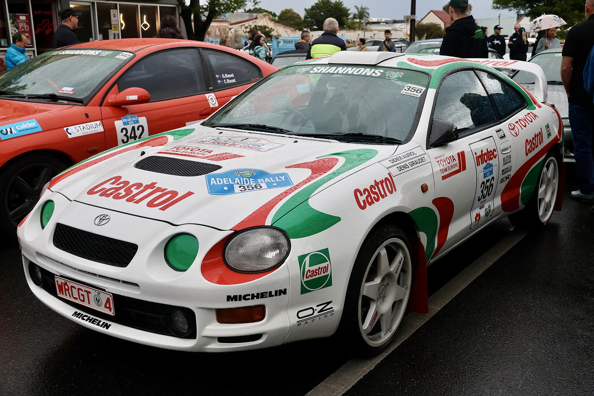 Toyota Celica GT-Four ST205 rally car in white, green and red Castrol livery with Adelaide Rally stickers on wet pavement