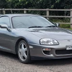 Toyota Supra Mk IV Turbo (1993–1998): Collector Spec Sheet Gray 1997 fourth-generation Toyota Supra Mk IV with factory five-spoke wheels, front three-quarter view