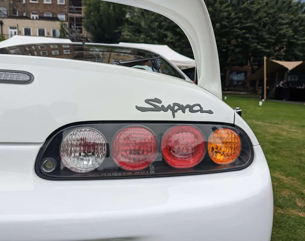 Round taillights and Supra script badge on the rear of a white 1995 Toyota Supra Mk IV