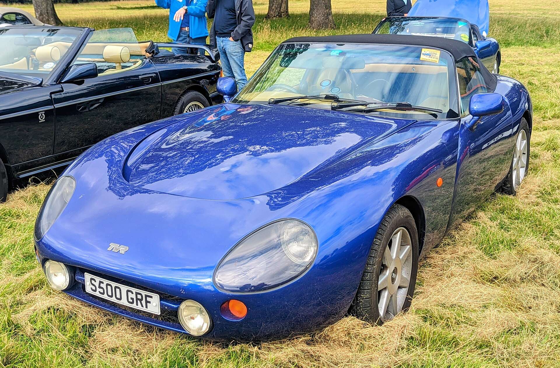 Front three-quarter view of a blue 1998 TVR Griffith 500 roadster parked on grass