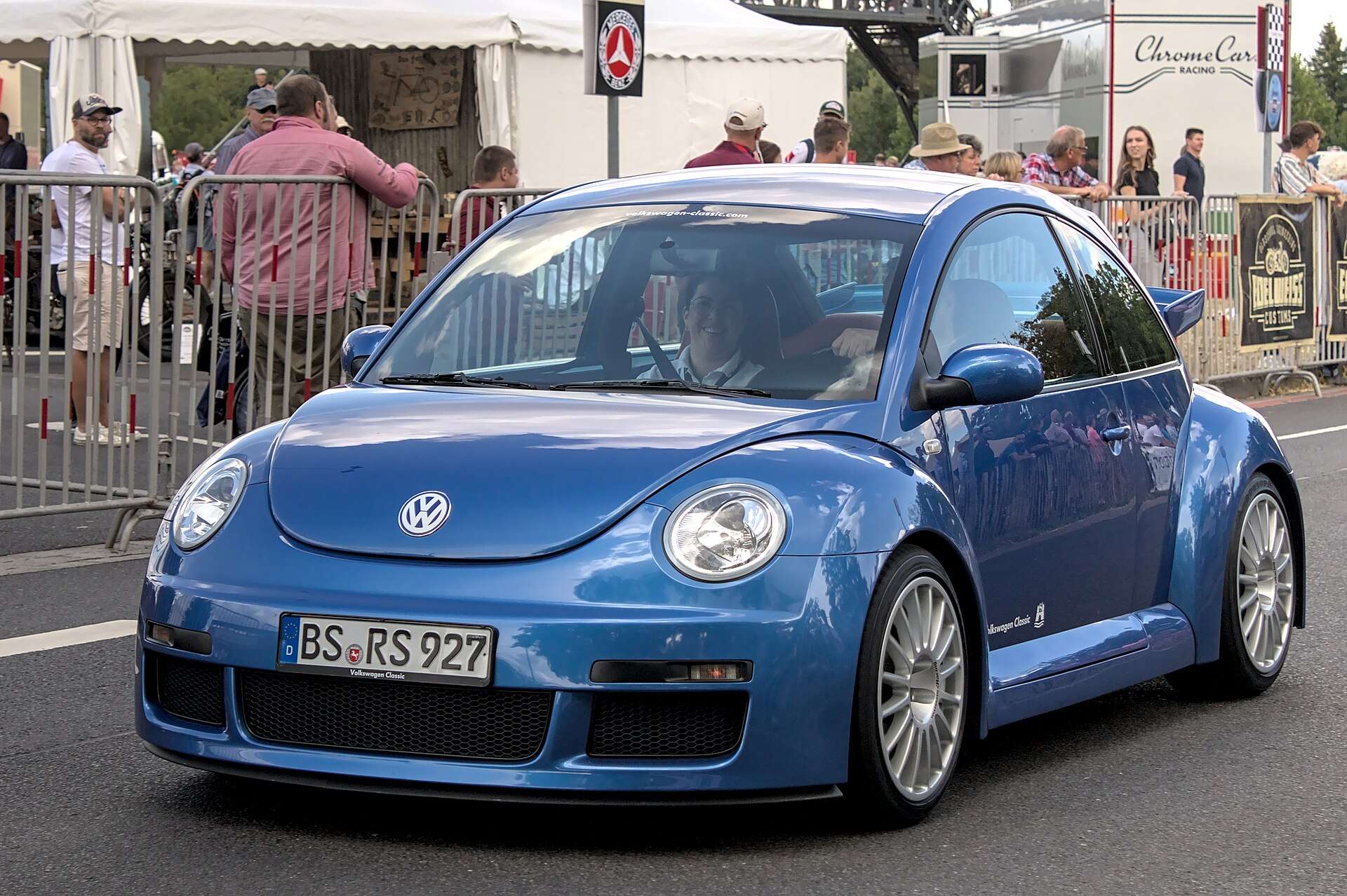 Blue Volkswagen New Beetle RSi driving past spectators at Classic Days 2022, front three-quarter view